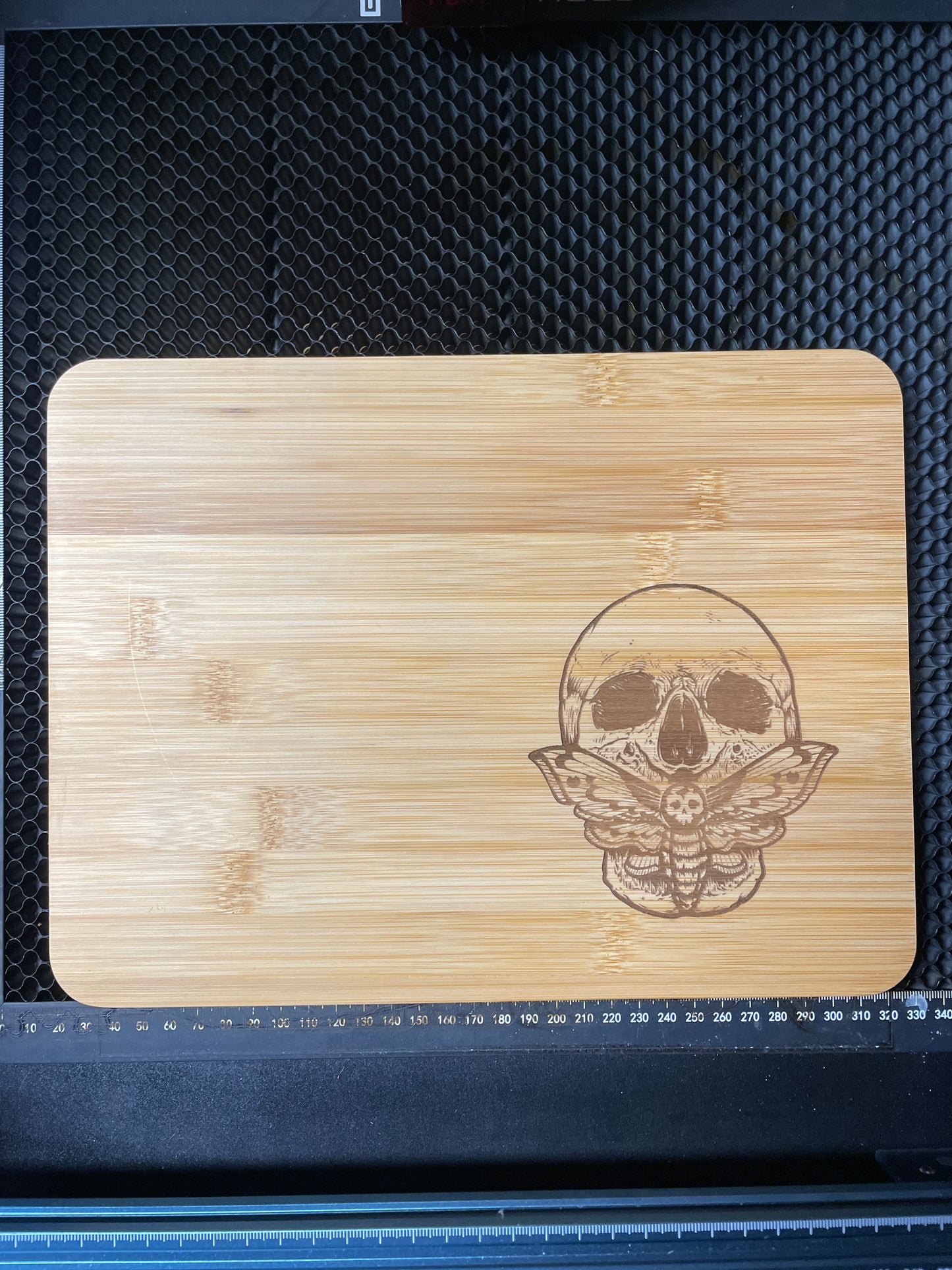 Death head moth and skull laser engraved bamboo cutting board.