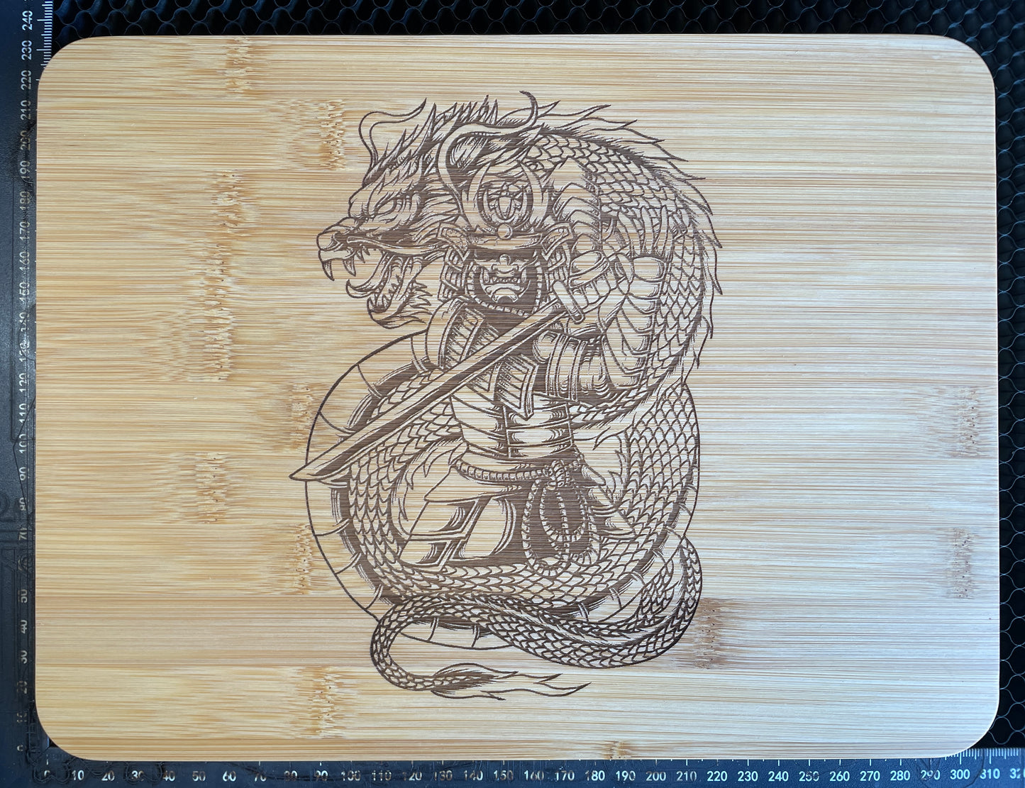 Samurai and Dragon laser engraved bamboo cutting board.