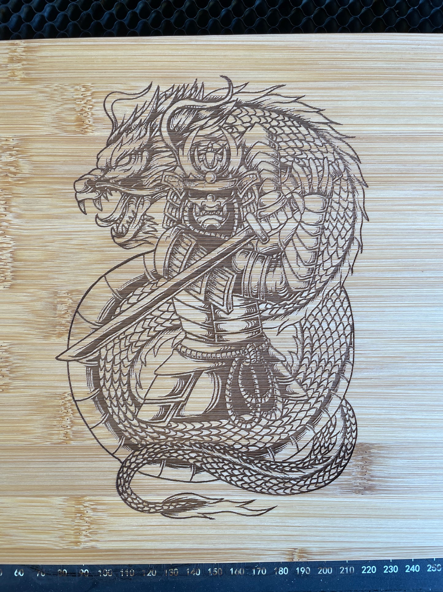 Samurai and Dragon laser engraved bamboo cutting board.