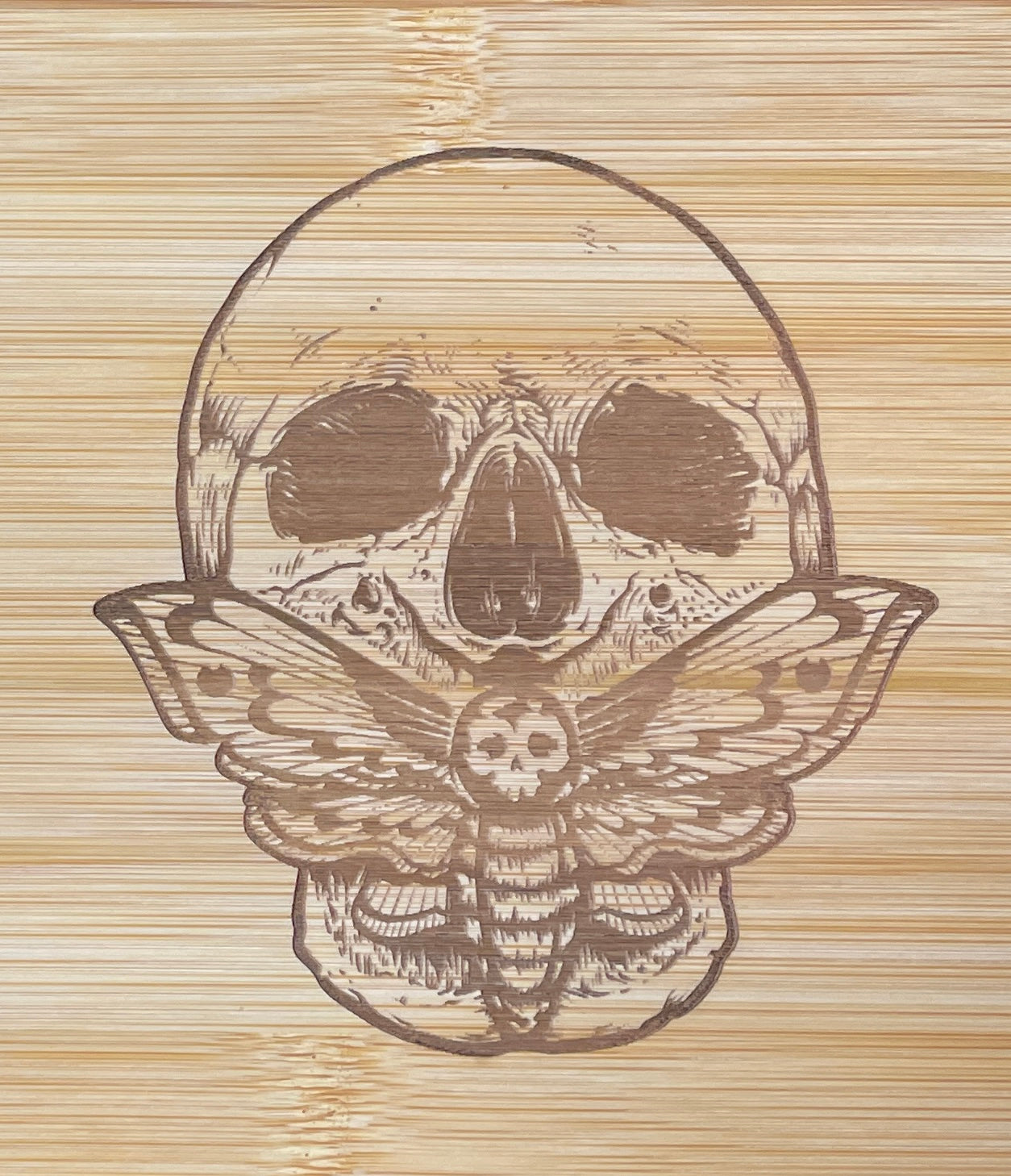Death head moth and skull laser engraved bamboo cutting board.
