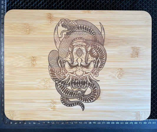 Samurai mask with snake laser engraved bamboo cutting board.